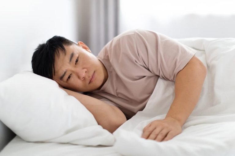 Upset Asian Man Lying In Bed In The Morning 2023 11 27 05 34 59 Utc (1)